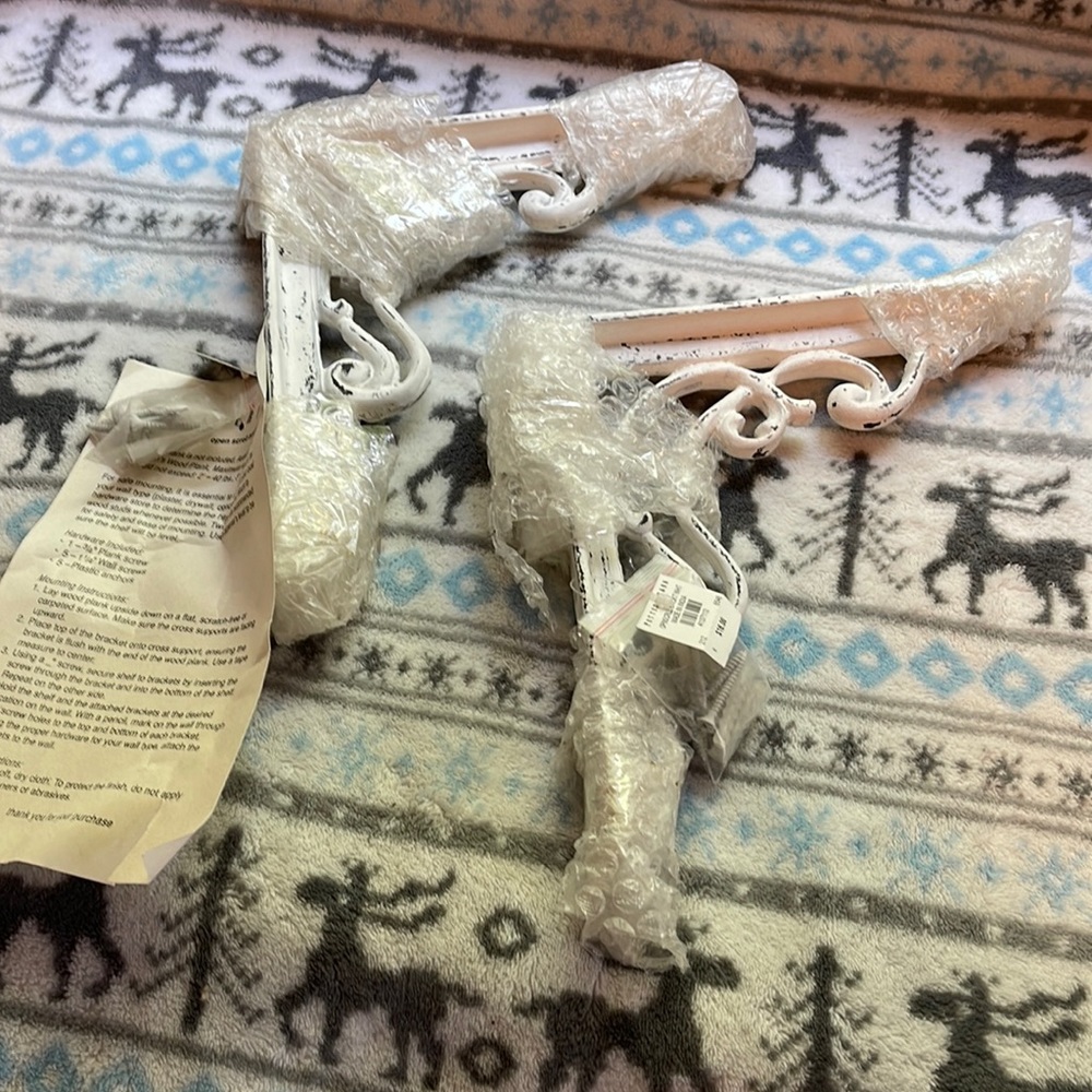 Pottery barn open scroll brackets to support shelf.